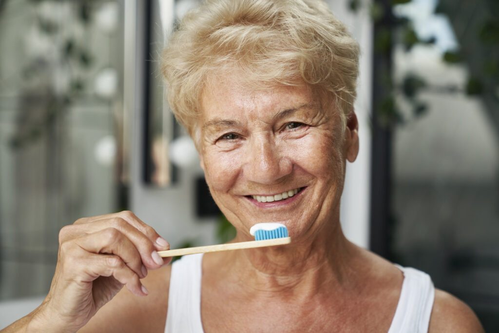 Senior woman about to brush her teeth